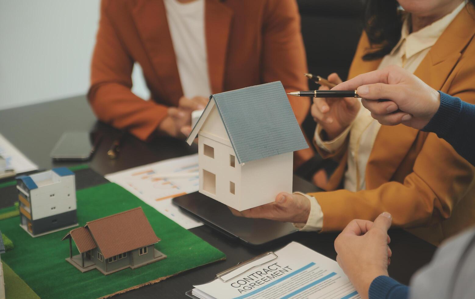 Team of architectures and businessmen discussing and brainstorming on floor plan modification for real estate investment and housing development project photo
