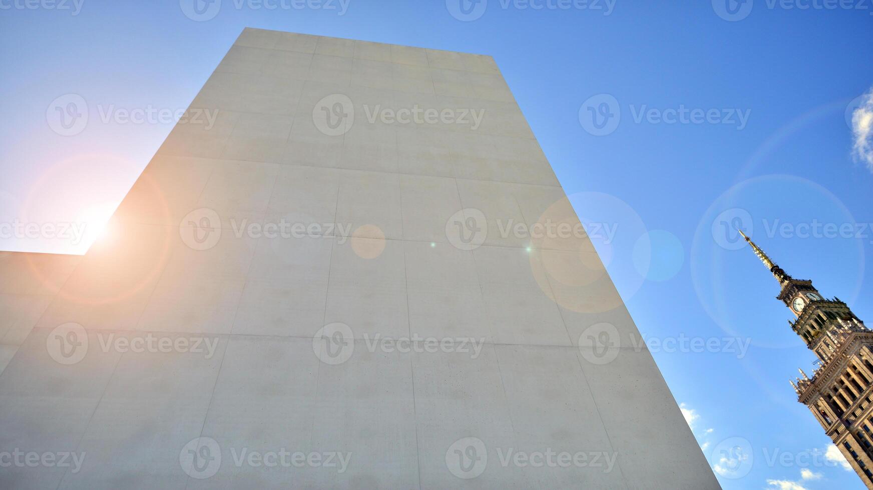 Sunlight and shadow on surface of white Concrete Building wall against blue sky background, Geometric Exterior Architecture in Minimal Street photography style photo