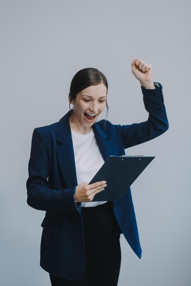 Young businesswoman hold with clipboard photo