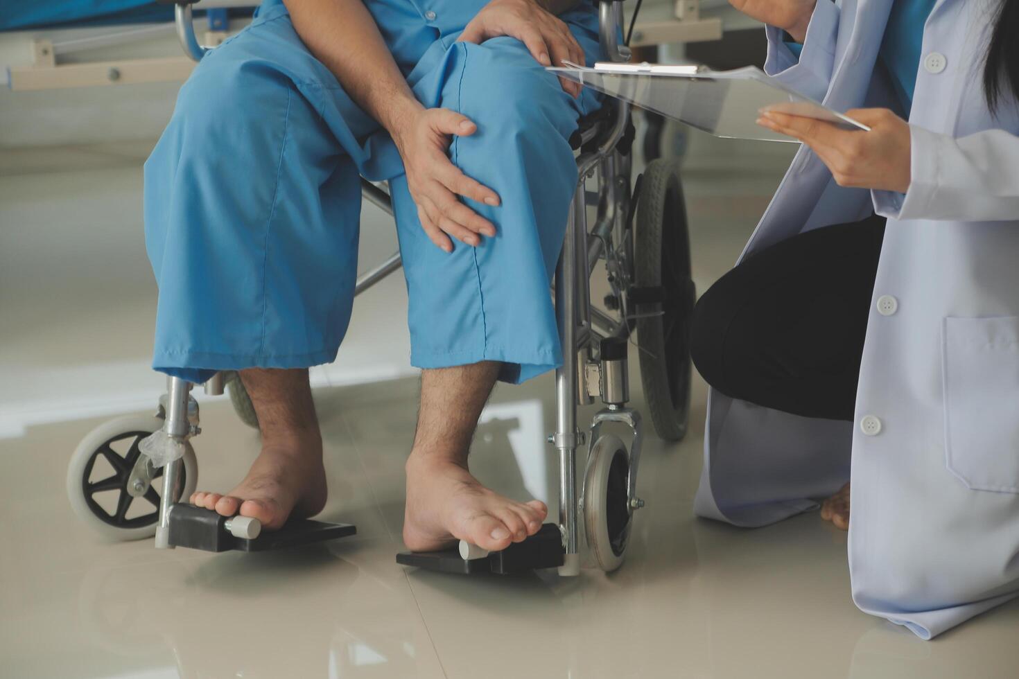 young asian physical therapist working with senior woman on walking with a walker photo