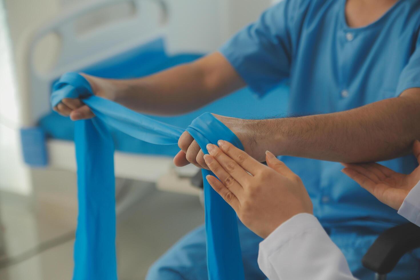 Physical therapist guiding patient with resistance band photo