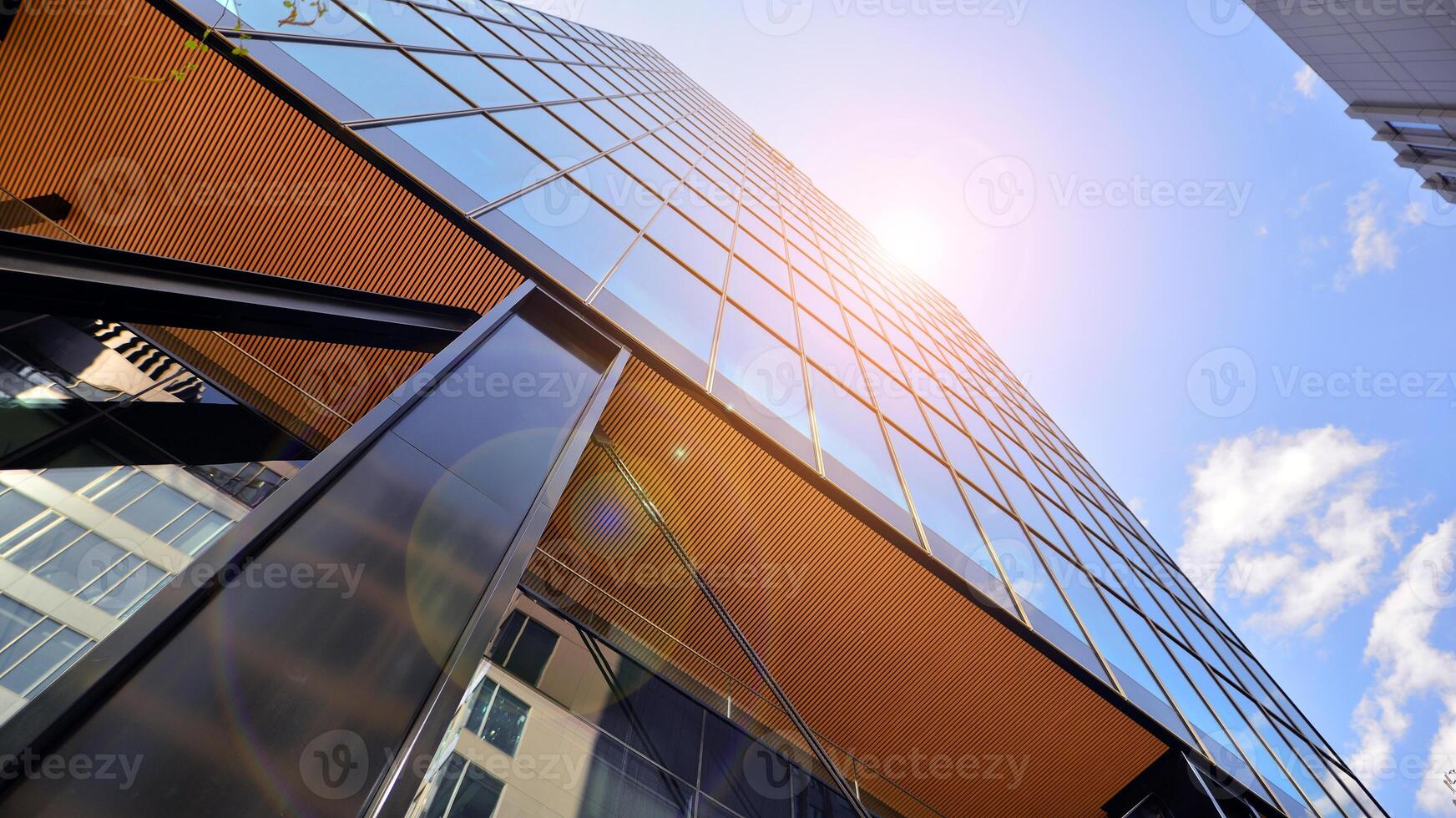 Steel and glass. The subject of modern architecture or construction industry. Modern office building facade with tall steel construction elements and full height windows between. photo