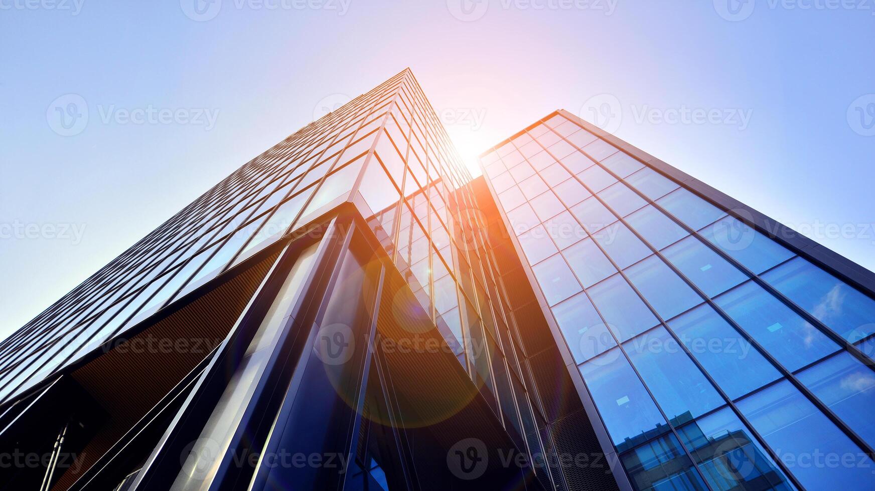 Steel and glass. The subject of modern architecture or construction industry. Modern office building facade with tall steel construction elements and full height windows between. photo