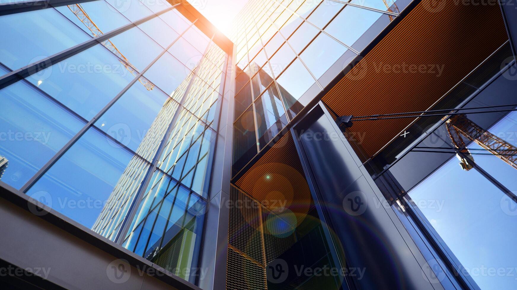 Steel and glass. The subject of modern architecture or construction industry. Modern office building facade with tall steel construction elements and full height windows between. photo
