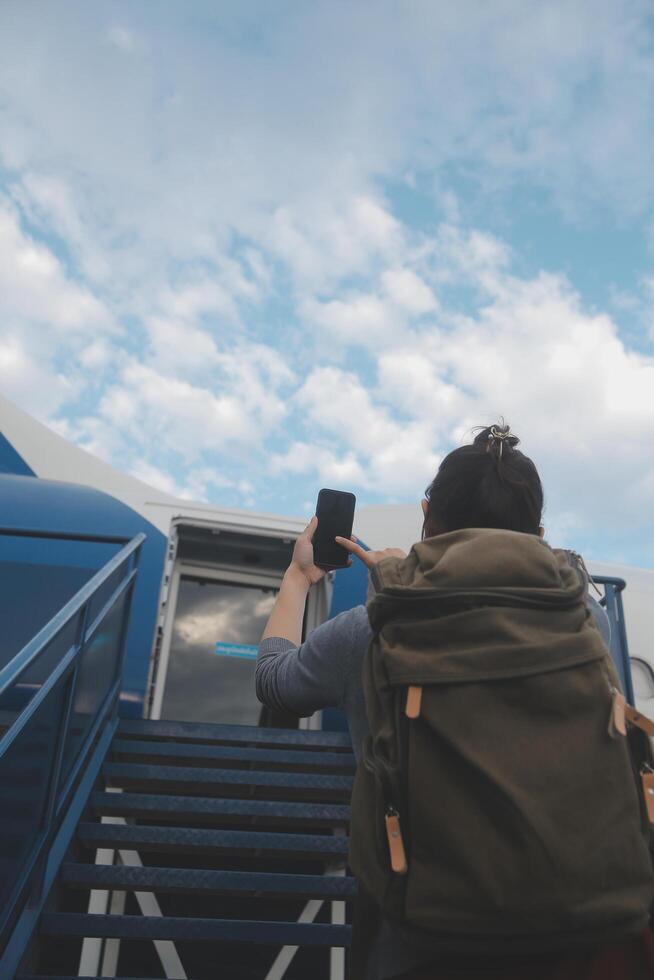 Happy attractive asian woman traveler with backpack at the modern airport terminal, copy space, Tourist journey trip concept photo