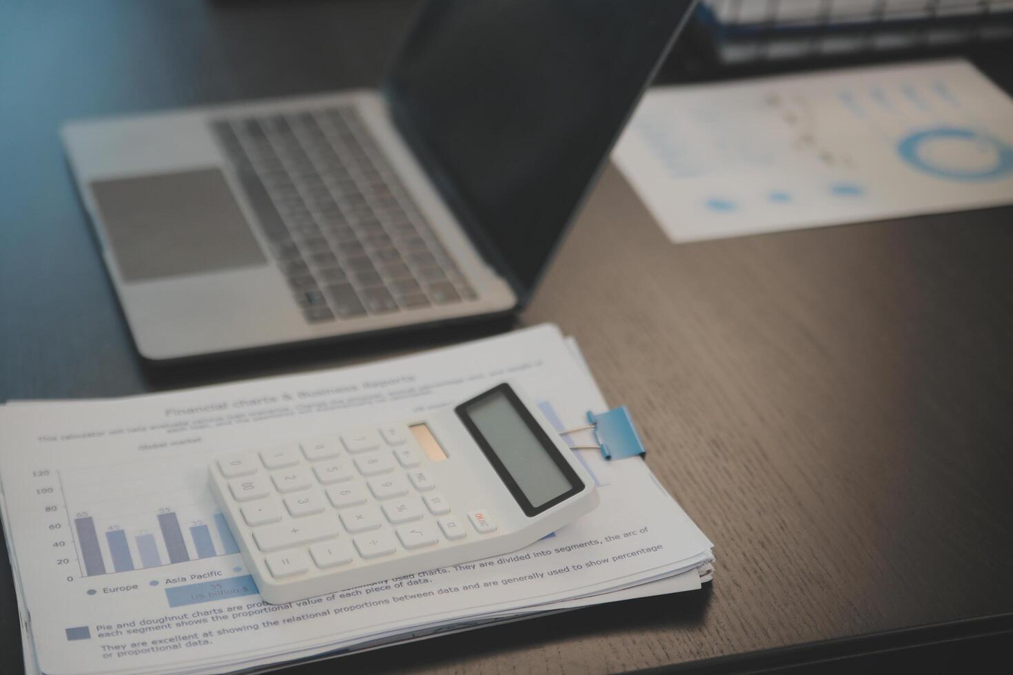 Laptop on a desk in an open financial office. photo
