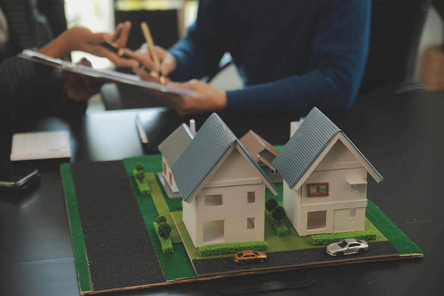 Team of architectures and businessmen discussing and brainstorming on floor plan modification for real estate investment and housing development project photo
