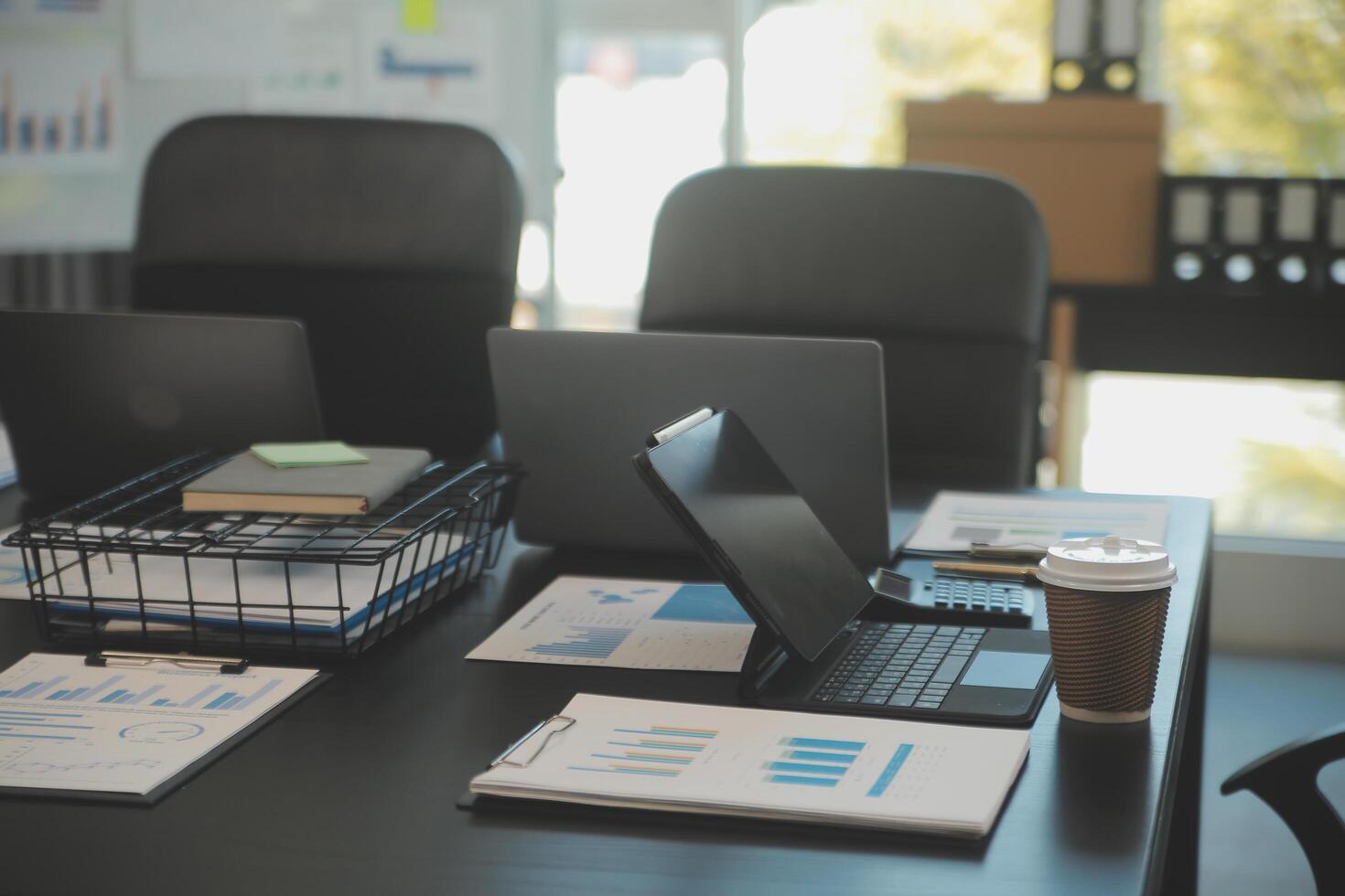 Laptop on a desk in an open financial office. photo