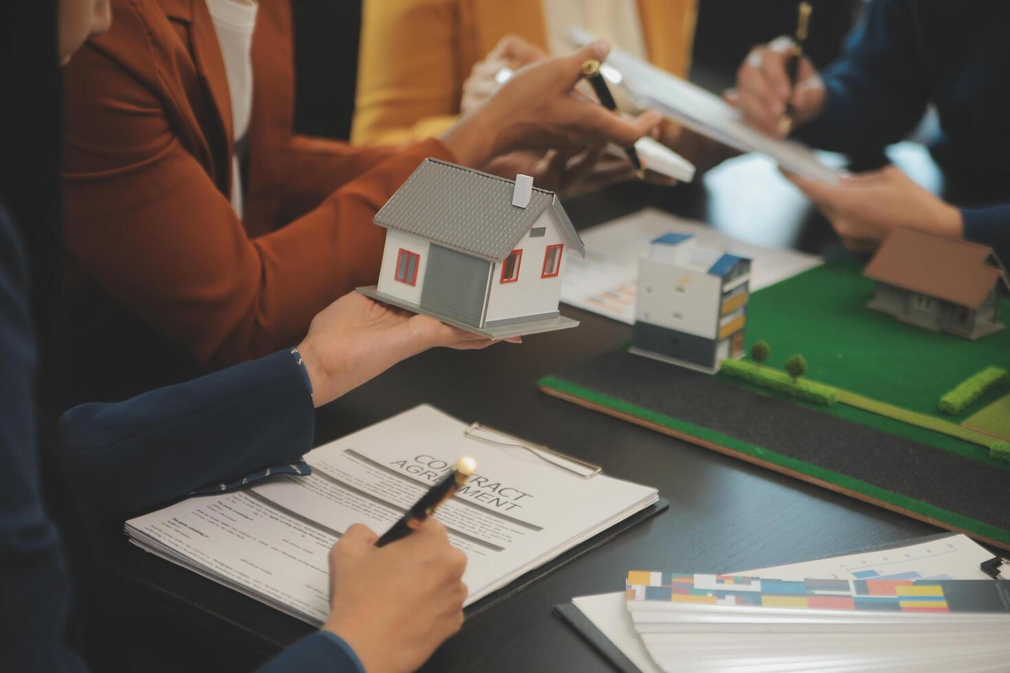 Team of architectures and businessmen discussing and brainstorming on floor plan modification for real estate investment and housing development project photo
