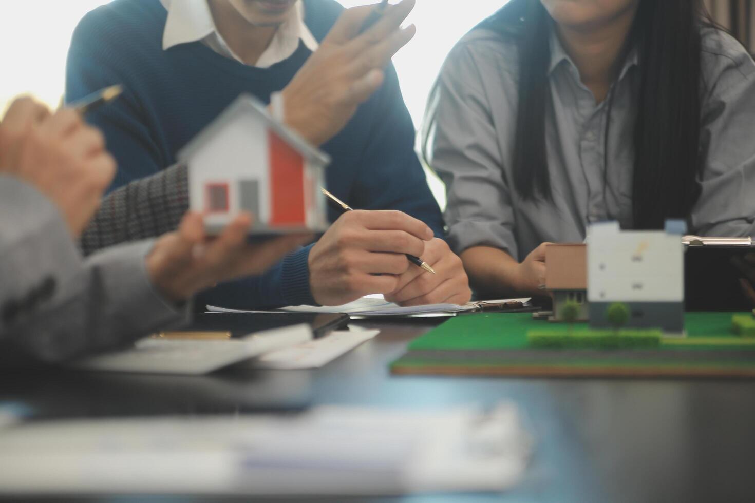 Team of architectures and businessmen discussing and brainstorming on floor plan modification for real estate investment and housing development project photo