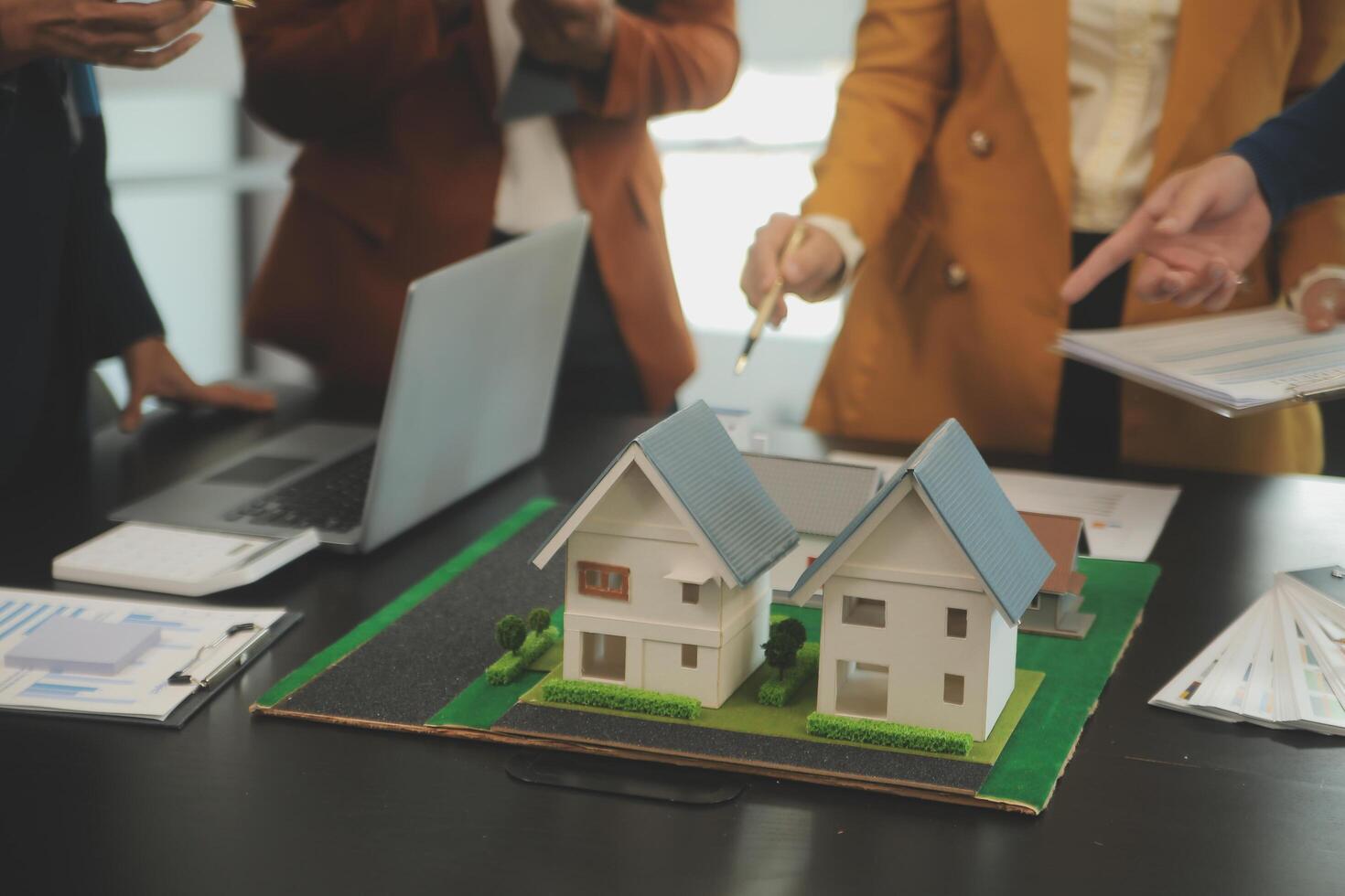 Team of architectures and businessmen discussing and brainstorming on floor plan modification for real estate investment and housing development project photo
