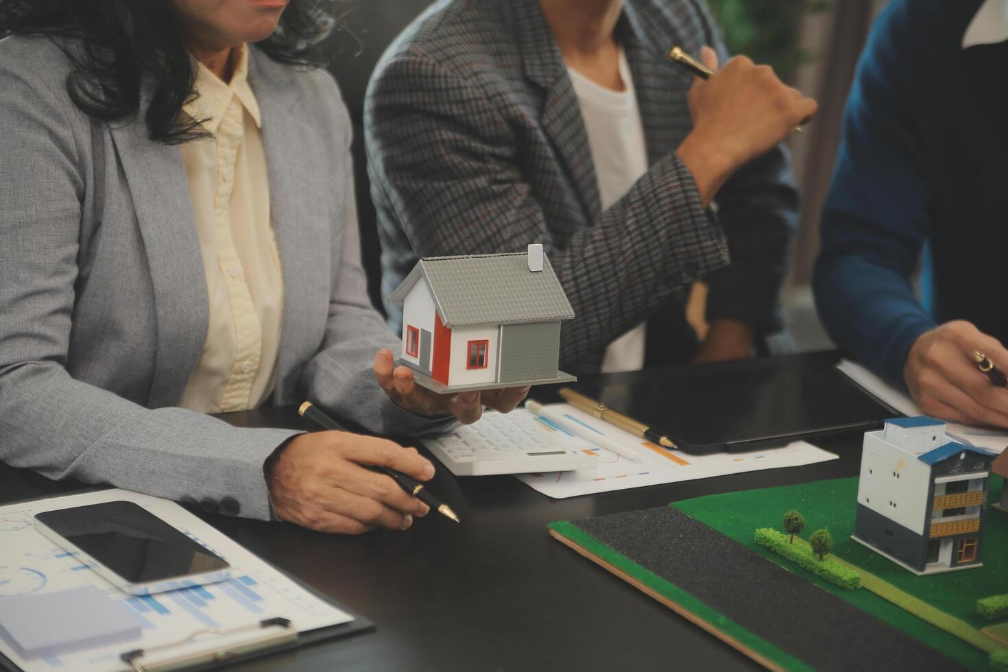 Team of architectures and businessmen discussing and brainstorming on floor plan modification for real estate investment and housing development project photo