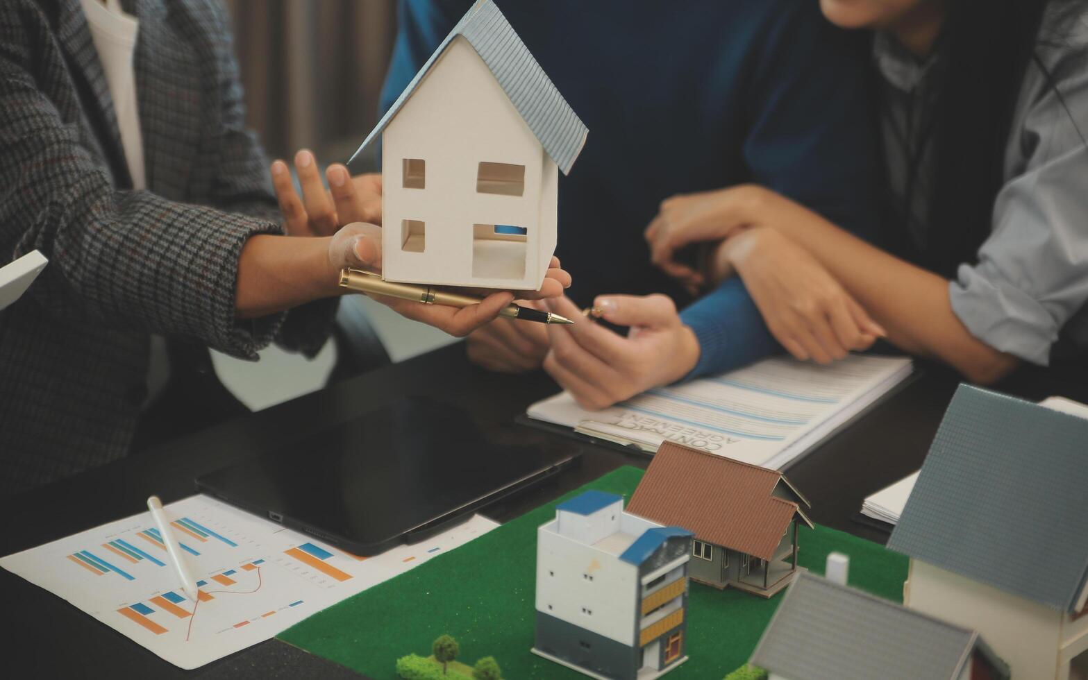 Team of architectures and businessmen discussing and brainstorming on floor plan modification for real estate investment and housing development project photo