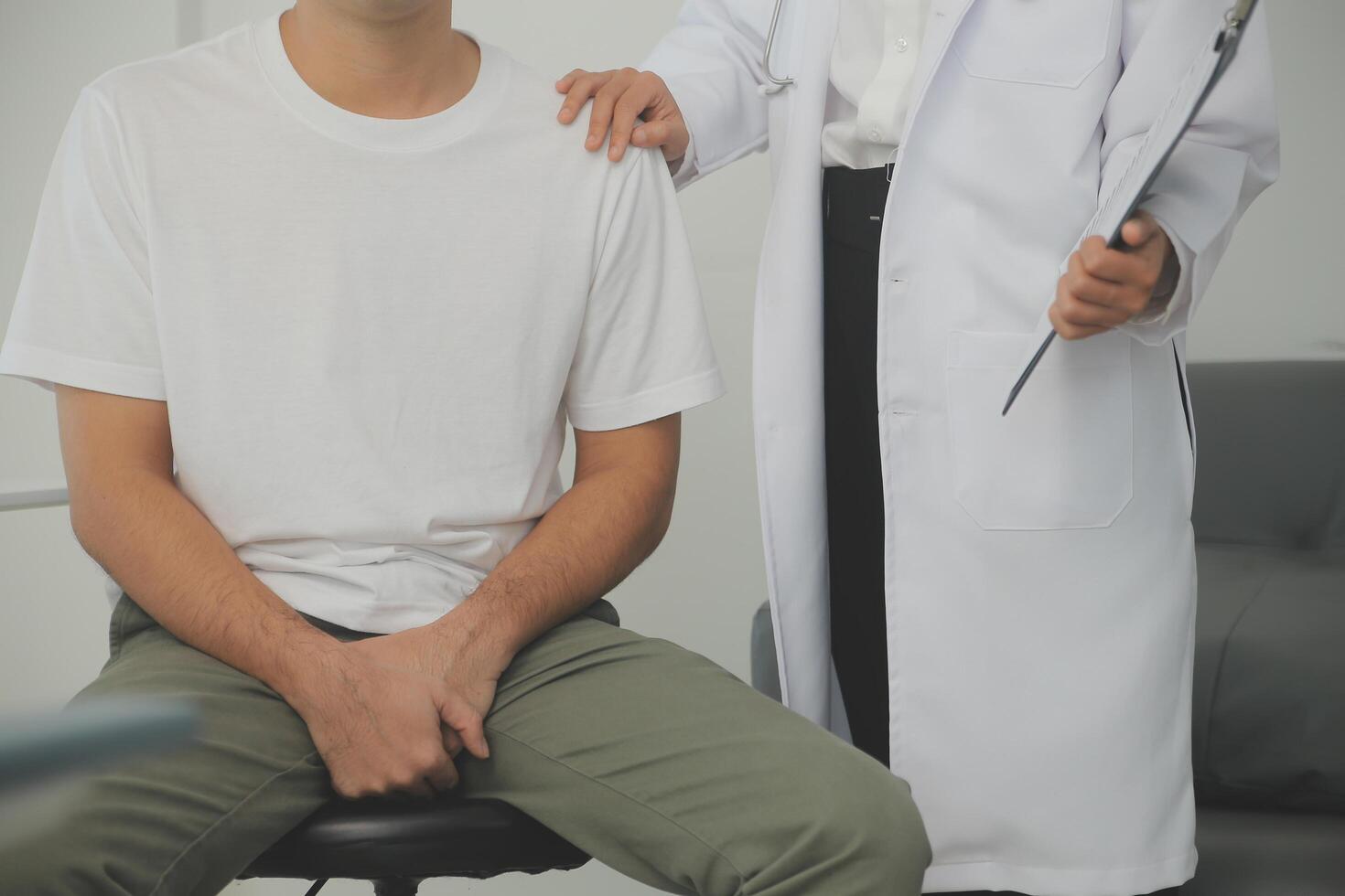 Male diseases. Man presses hands to his groin and suffering from pain, panorama, cropped, studio shot photo