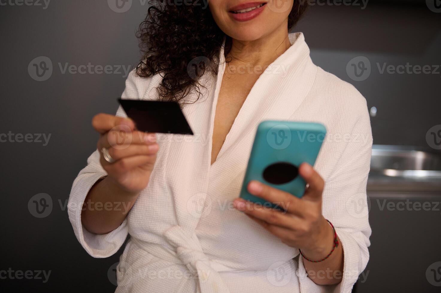 Close-up woman hands holding blank black credit card and smartphone with empty mockup digital screen, transferring money via internet banking, making payment, using mobile app. Copy advertising space photo