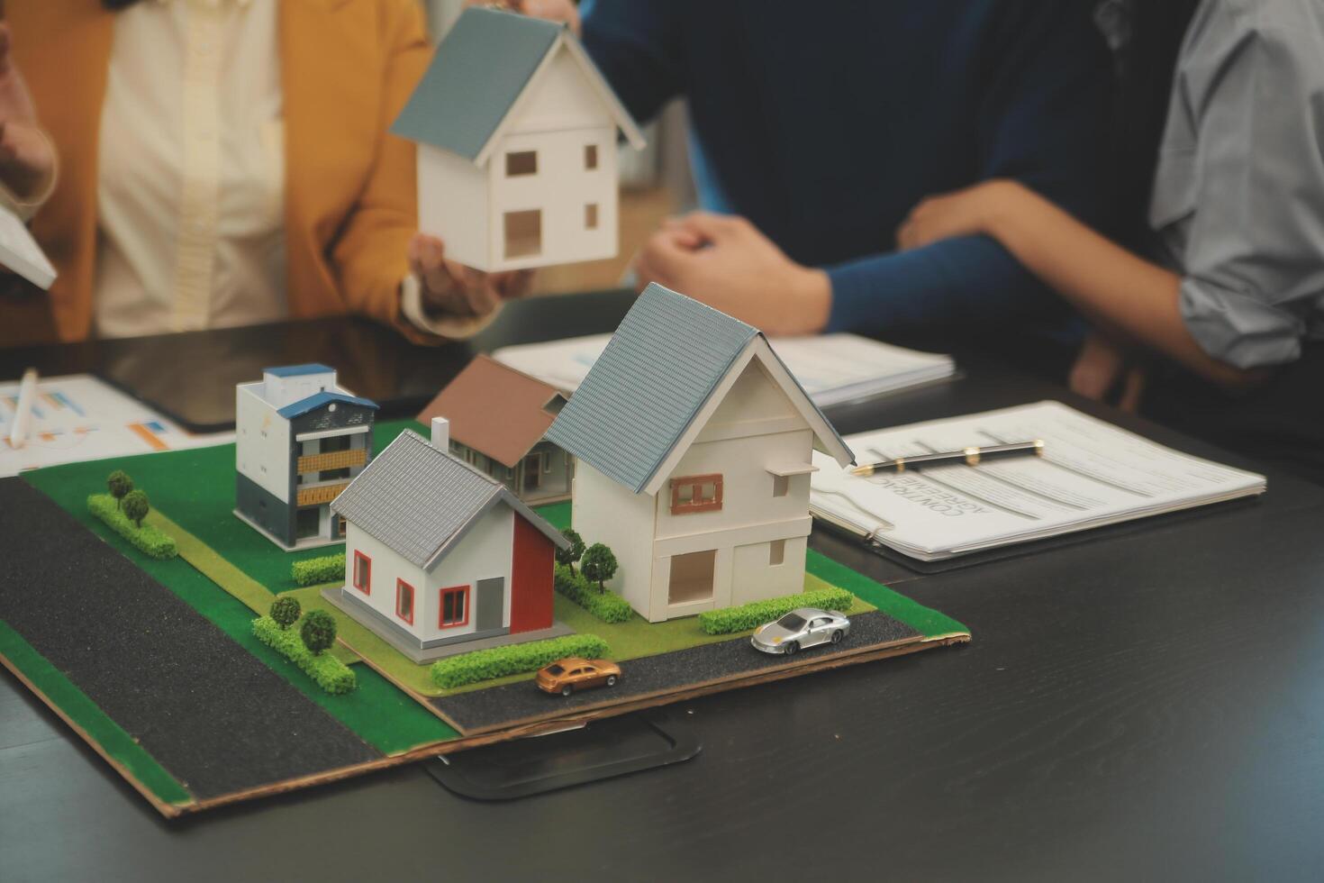 Team of architectures and businessmen discussing and brainstorming on floor plan modification for real estate investment and housing development project photo