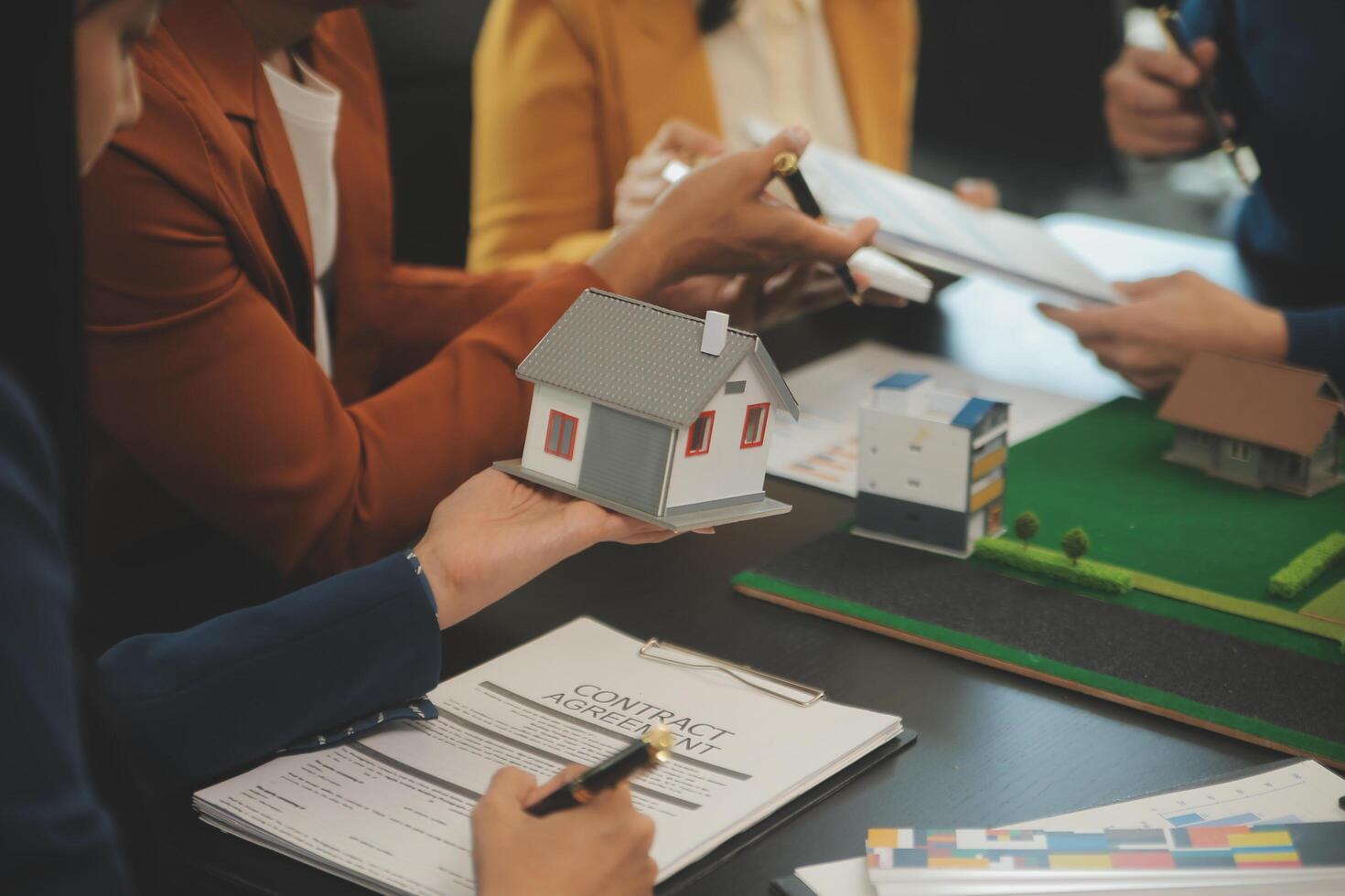 Team of architectures and businessmen discussing and brainstorming on floor plan modification for real estate investment and housing development project photo