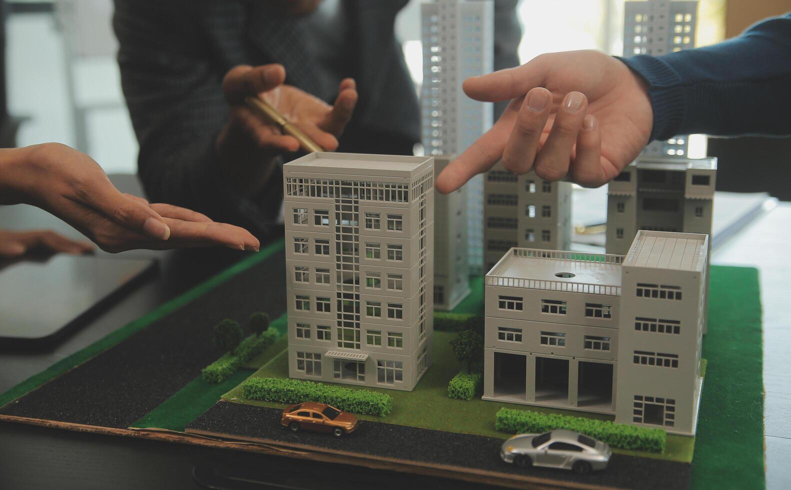 Team of architectures and businessmen discussing and brainstorming on floor plan modification for real estate investment and housing development project photo