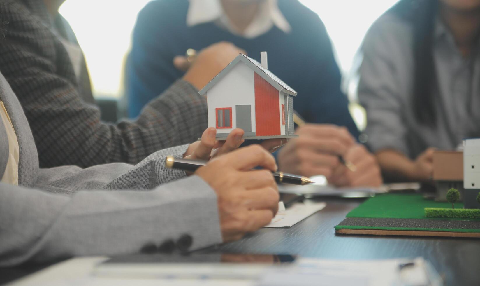 Team of architectures and businessmen discussing and brainstorming on floor plan modification for real estate investment and housing development project photo