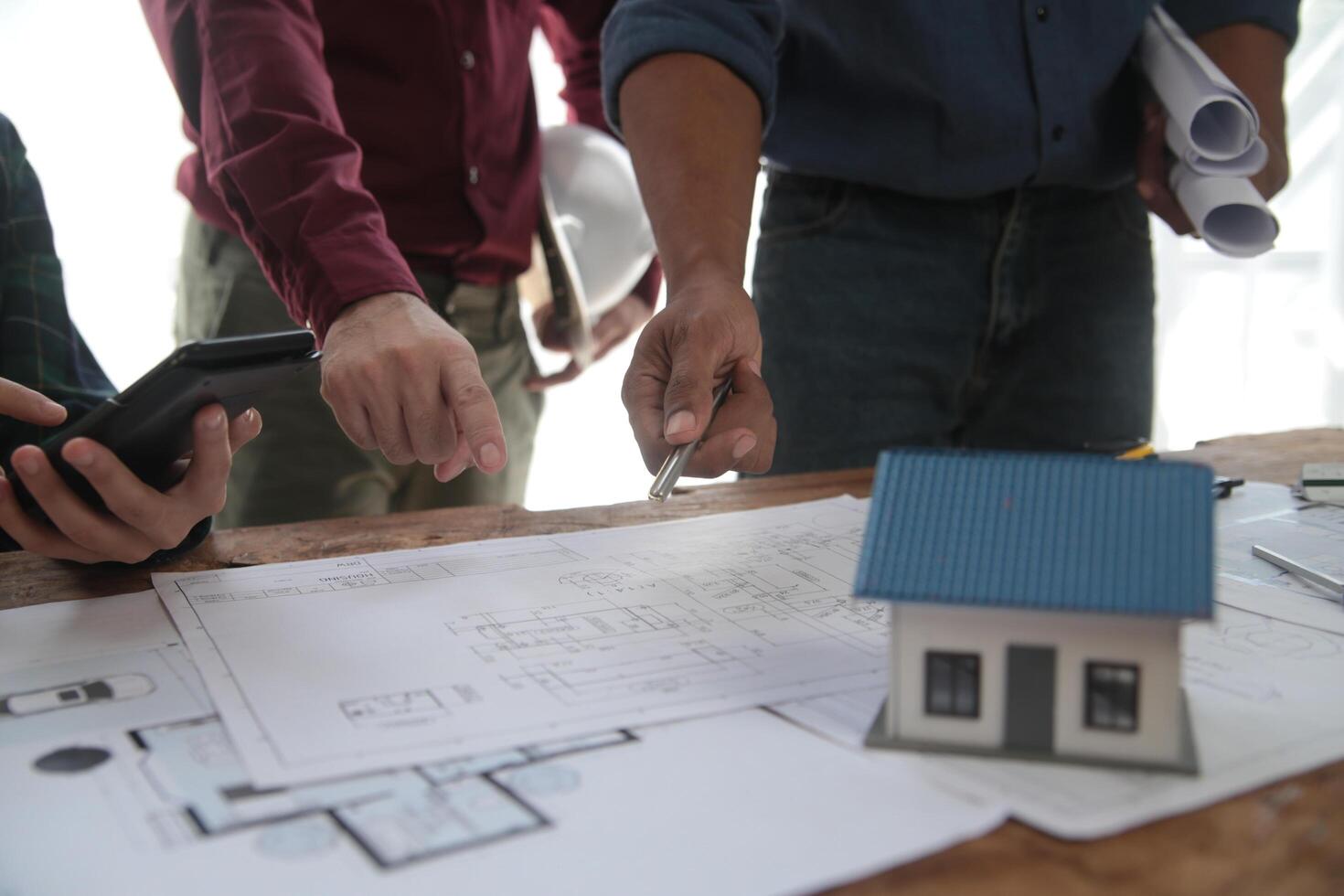 Diverse Team of Specialists Use Laptop on Construction Site. Real Estate Building Project with Engineer Investor and Businessman Checking Area, working on Civil Engineering, Discussing Strategy Plan photo