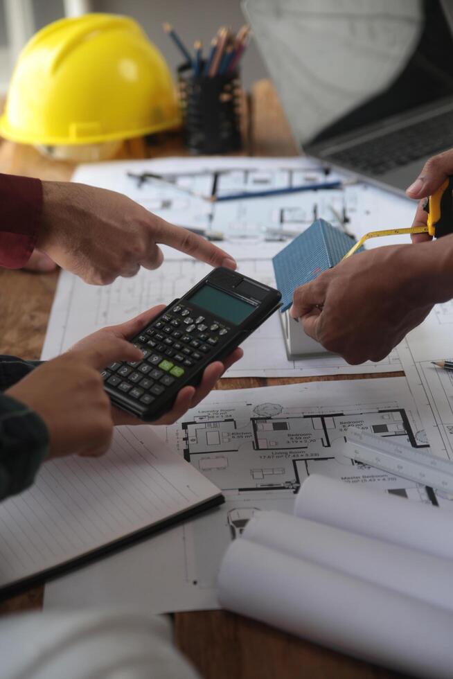 Construction and structure concept of Engineer or architect meeting for project working with partner and engineering tools on model building and blueprint in working site, contract for both companies. photo