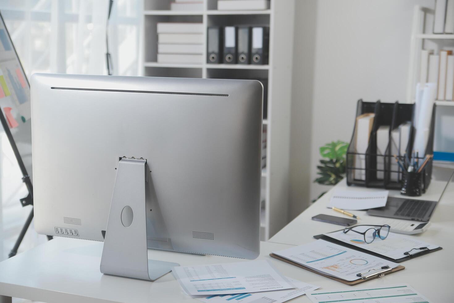 Laptop computer with opened lid on table in meeting room of office workspace. photo