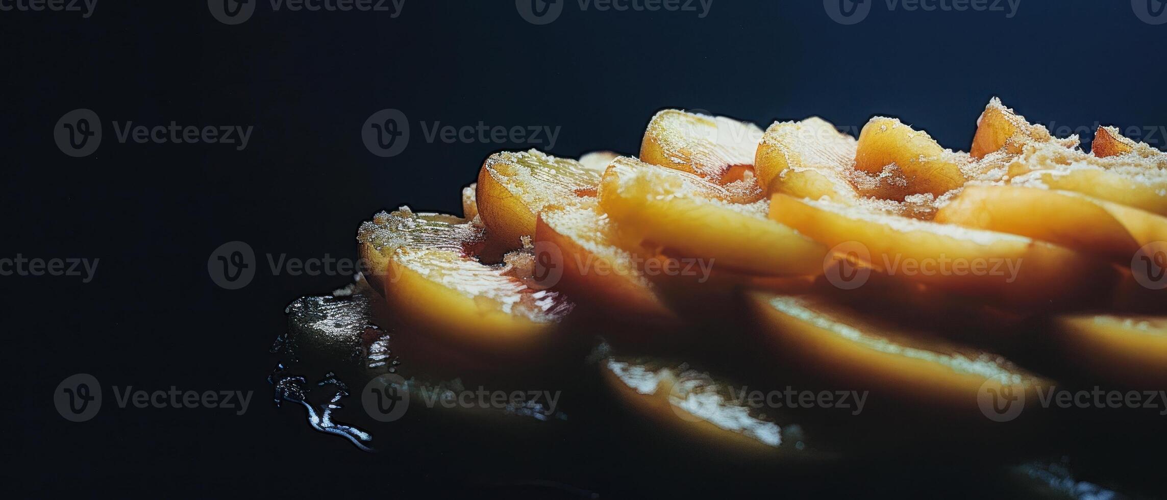 A close up of a delicious looking baked peach tart with a dark background. photo