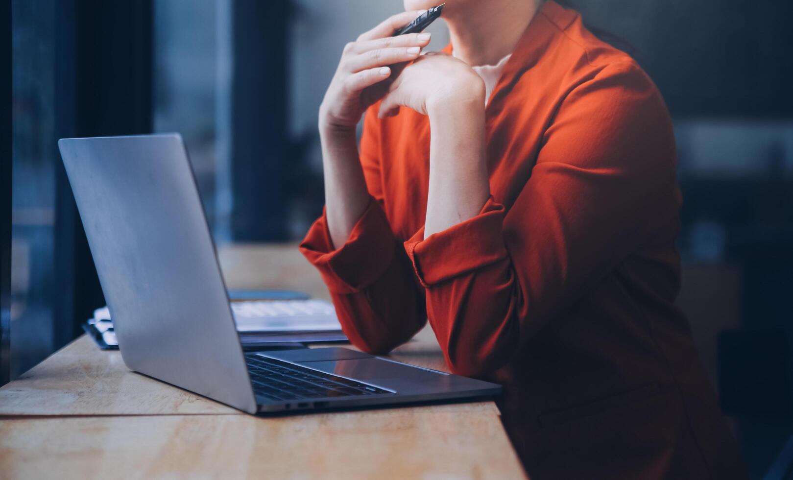 Asian Business woman using calculator and laptop for doing math finance on an office desk, tax, report, accounting, statistics, and analytical research concept photo