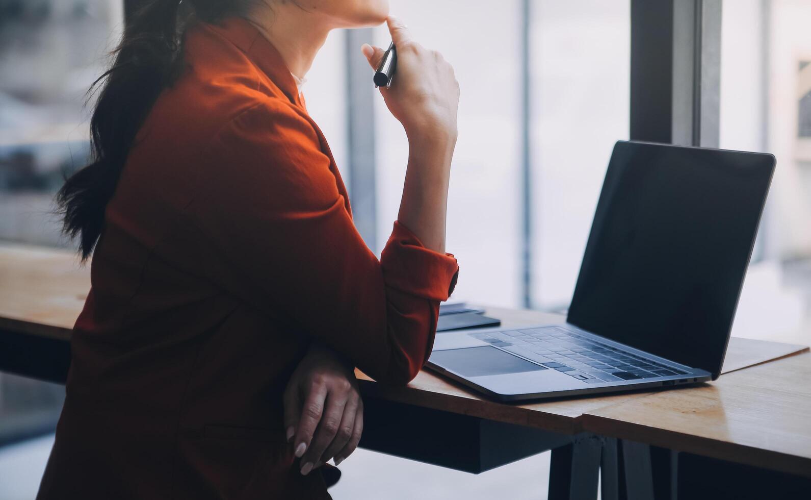 Asian Business woman using calculator and laptop for doing math finance on an office desk, tax, report, accounting, statistics, and analytical research concept photo