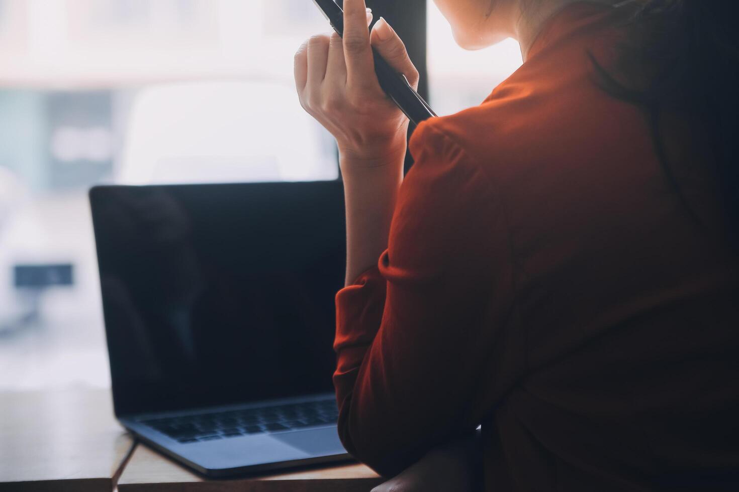 Asian Business woman using calculator and laptop for doing math finance on an office desk, tax, report, accounting, statistics, and analytical research concept photo