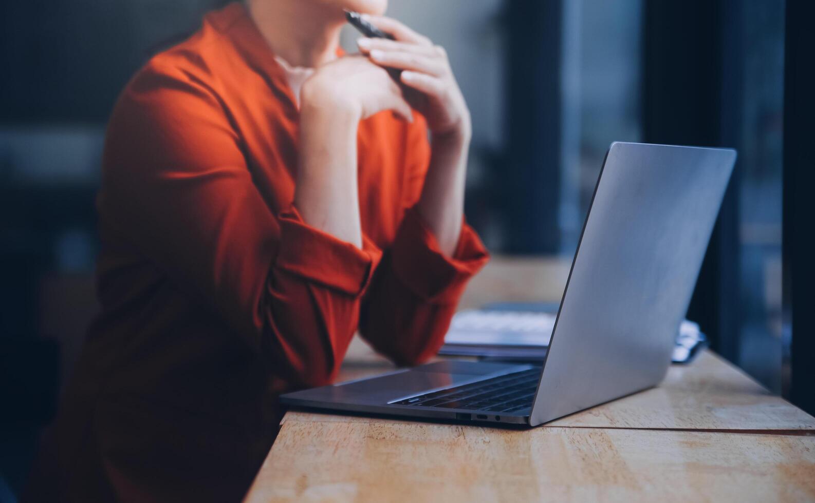 Asian Business woman using calculator and laptop for doing math finance on an office desk, tax, report, accounting, statistics, and analytical research concept photo