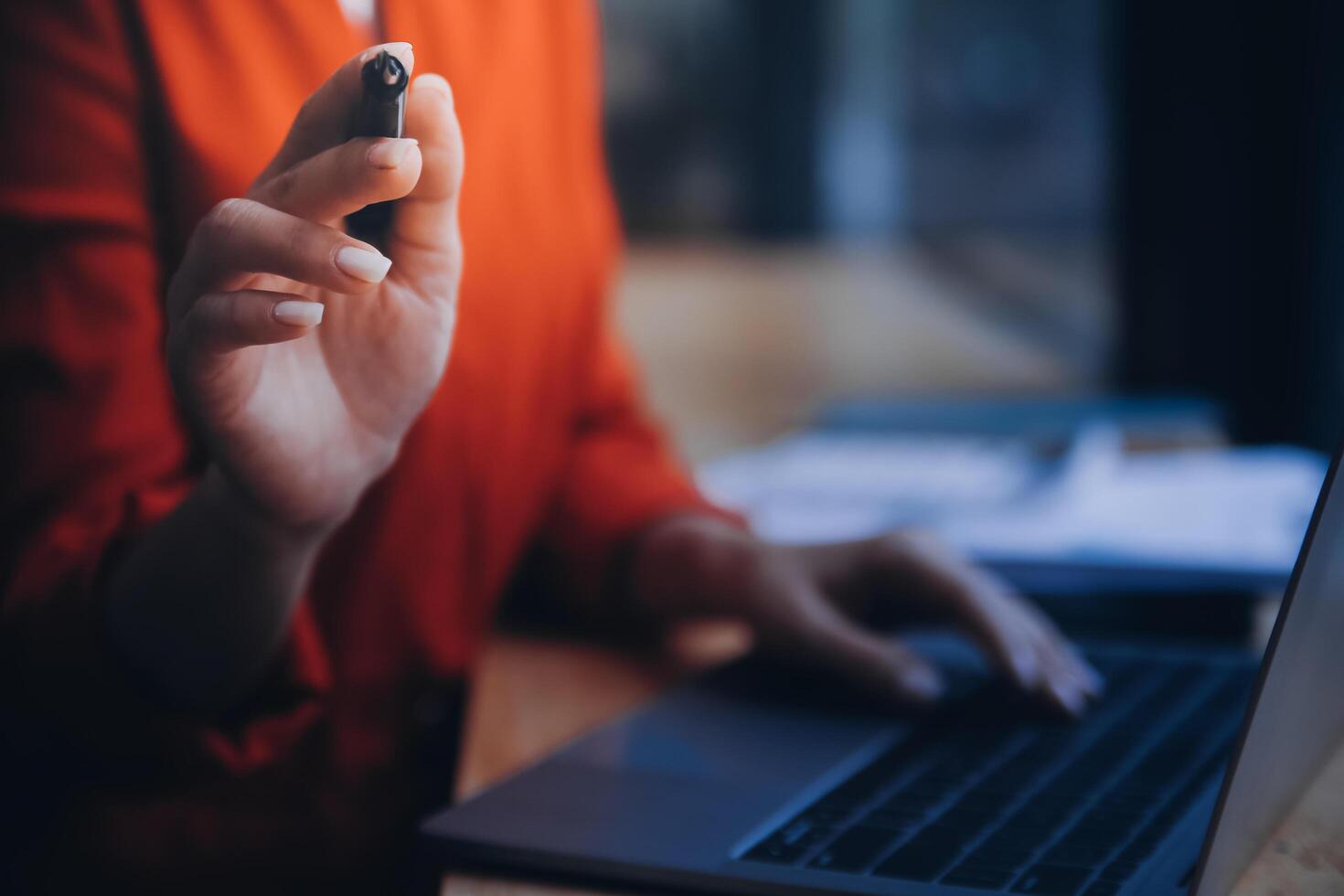 Asian Business woman using calculator and laptop for doing math finance on an office desk, tax, report, accounting, statistics, and analytical research concept photo