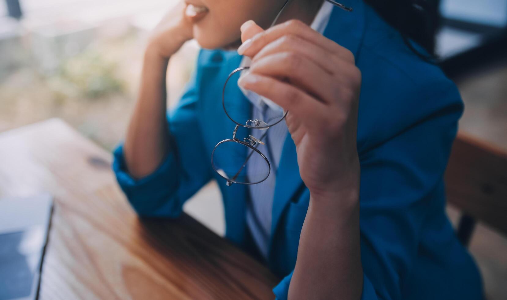 Asian Business woman using calculator and laptop for doing math finance on an office desk, tax, report, accounting, statistics, and analytical research concept photo