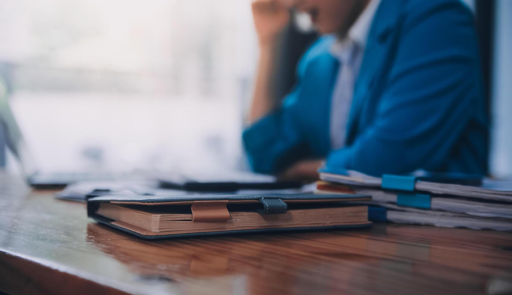 Asian Business woman using calculator and laptop for doing math finance on an office desk, tax, report, accounting, statistics, and analytical research concept photo