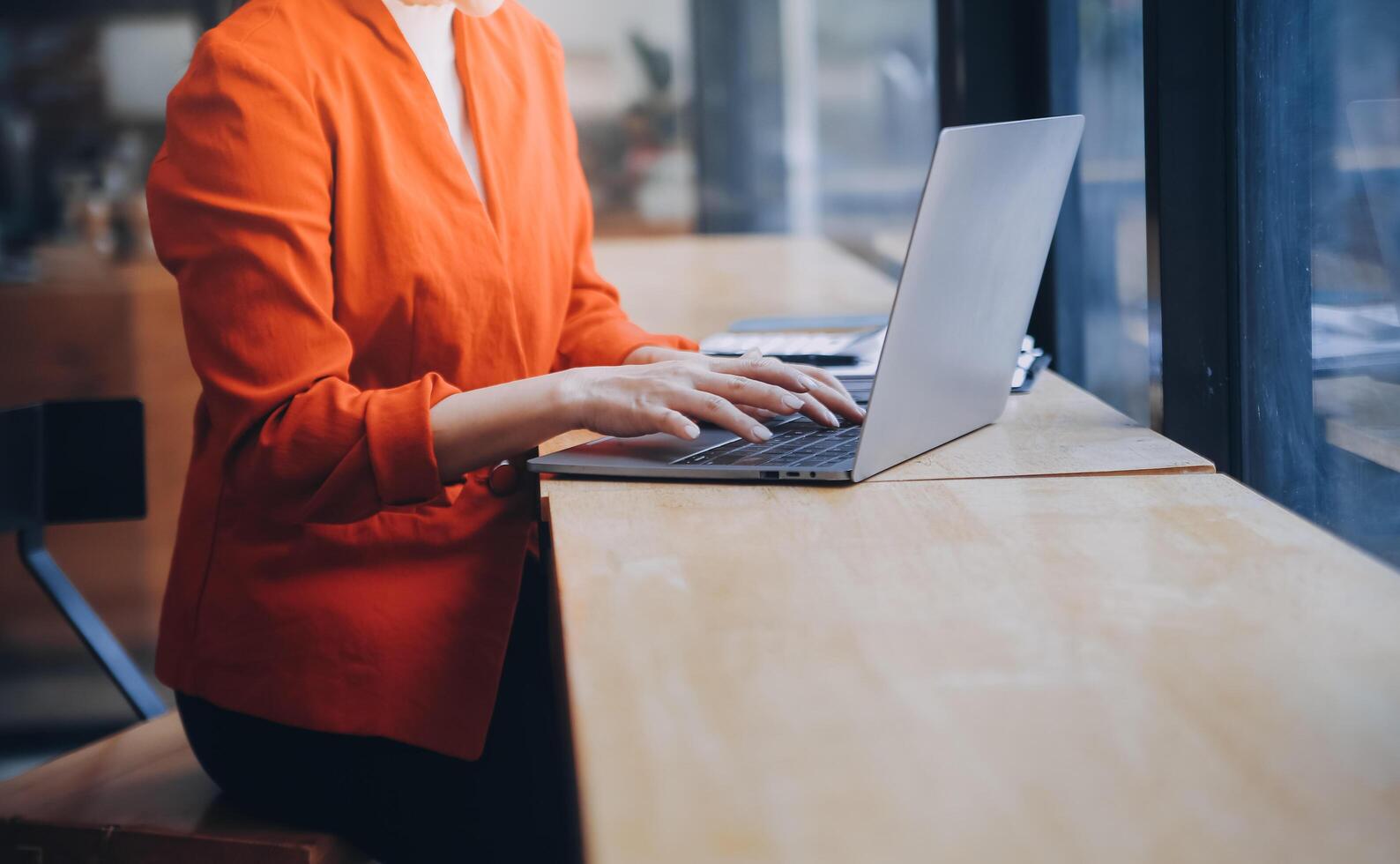 Asian Business woman using calculator and laptop for doing math finance on an office desk, tax, report, accounting, statistics, and analytical research concept photo