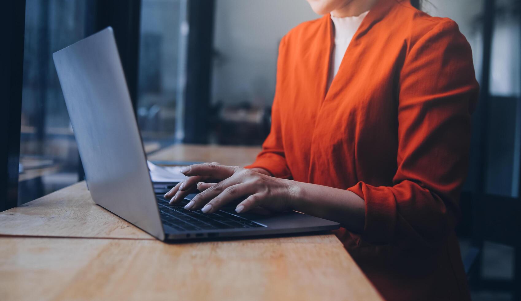 Asian Business woman using calculator and laptop for doing math finance on an office desk, tax, report, accounting, statistics, and analytical research concept photo
