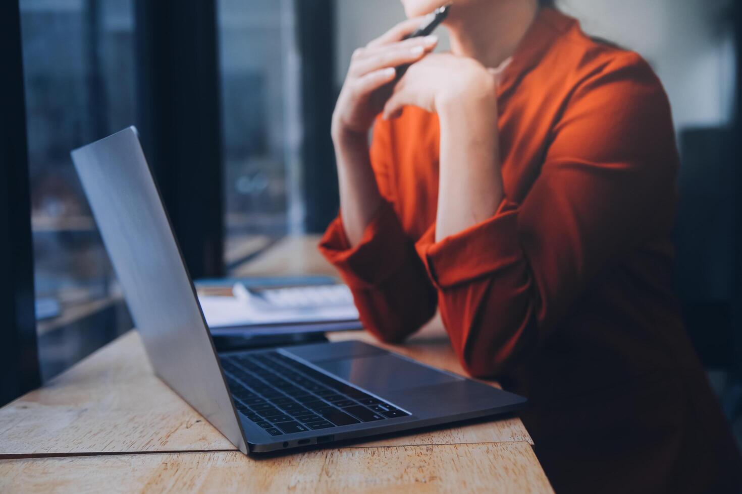 Asian Business woman using calculator and laptop for doing math finance on an office desk, tax, report, accounting, statistics, and analytical research concept photo