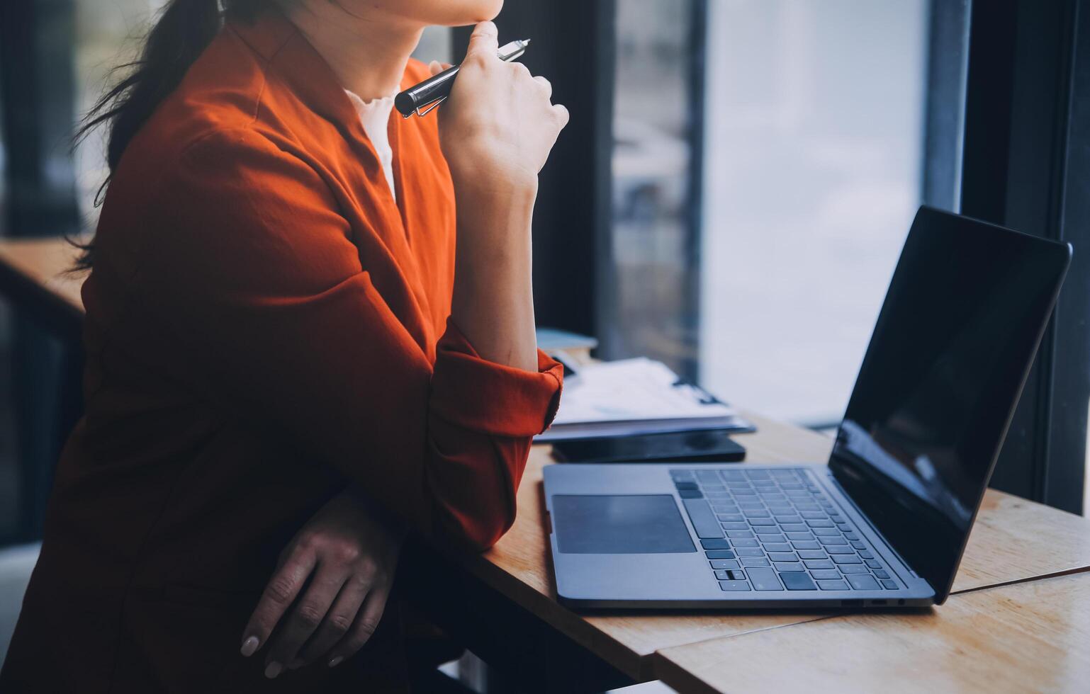 Asian Business woman using calculator and laptop for doing math finance on an office desk, tax, report, accounting, statistics, and analytical research concept photo