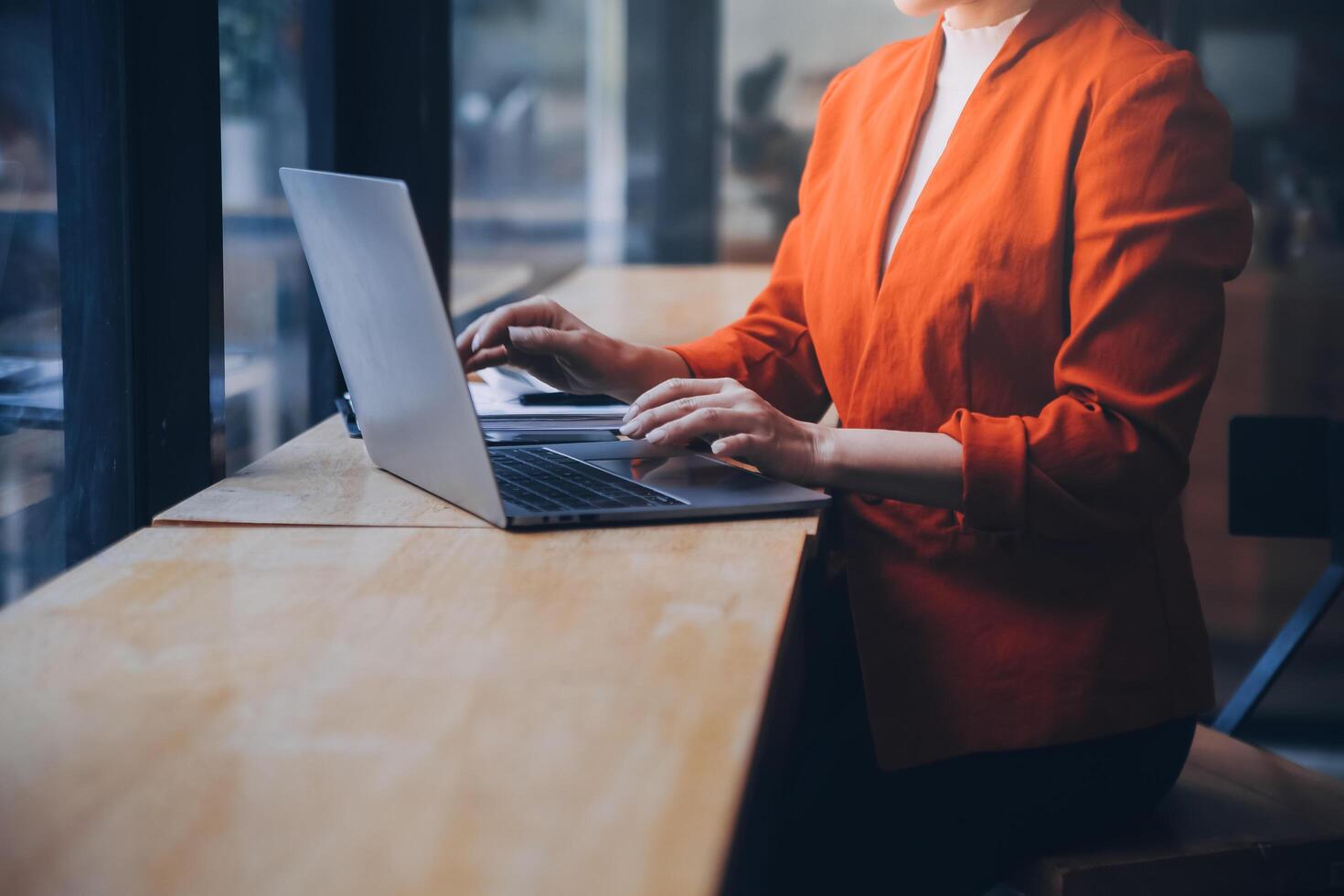 Asian Business woman using calculator and laptop for doing math finance on an office desk, tax, report, accounting, statistics, and analytical research concept photo