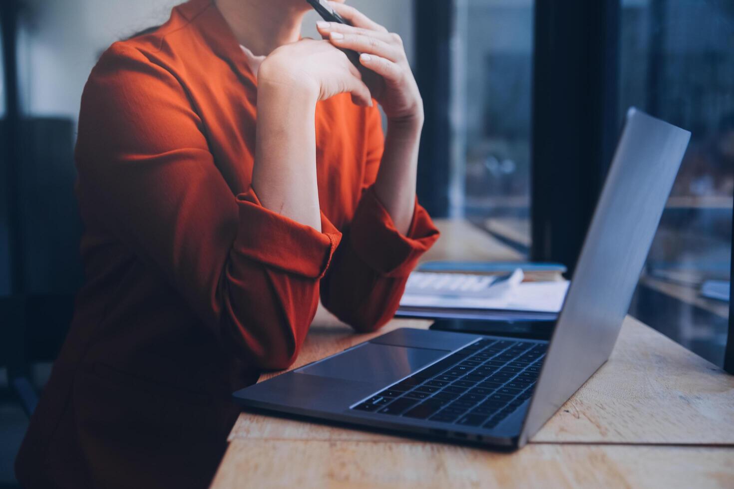 Asian Business woman using calculator and laptop for doing math finance on an office desk, tax, report, accounting, statistics, and analytical research concept photo