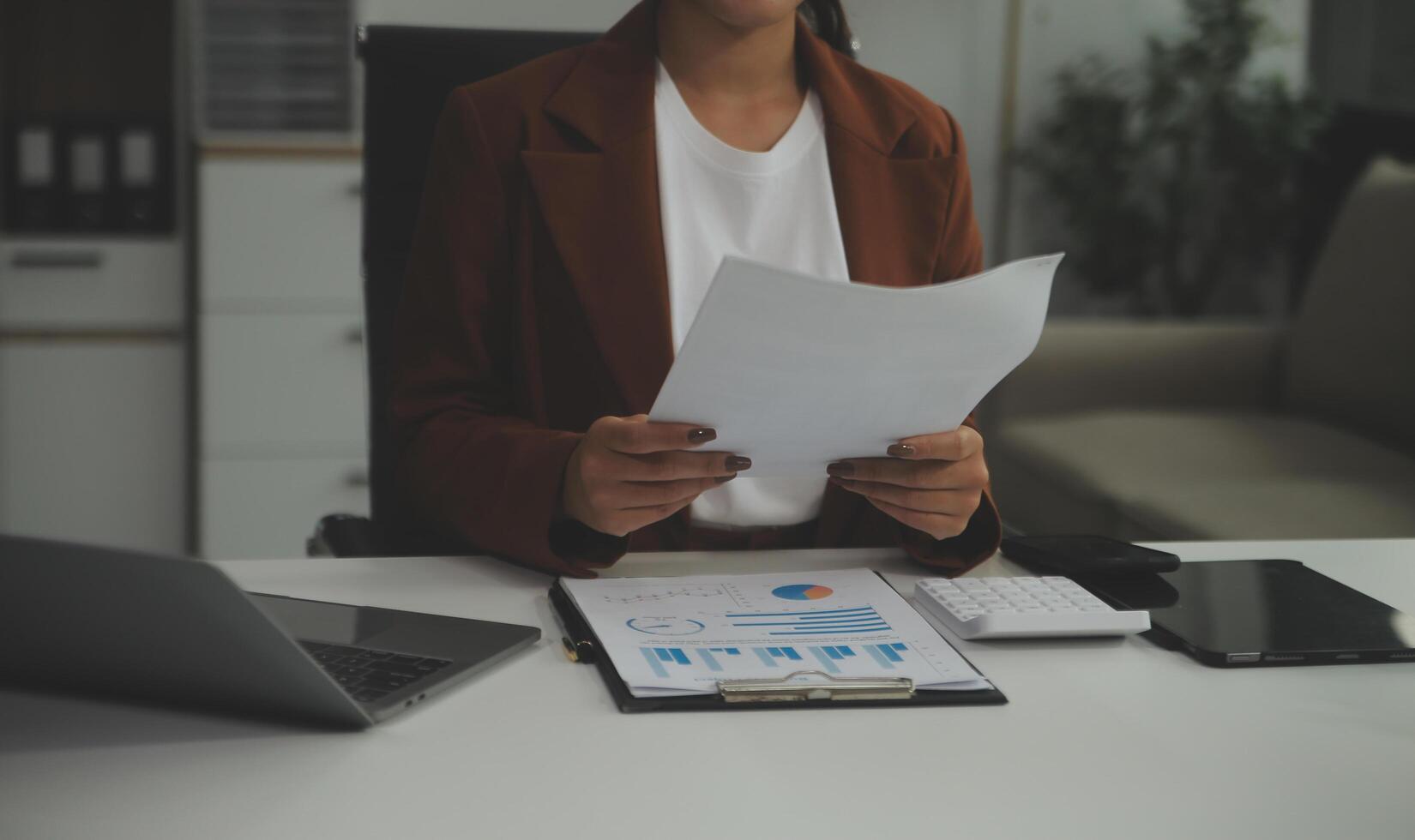 Business Documents, Auditor businesswoman checking searching document legal prepare paperwork or report for analysis TAX time,accountant Documents data contract partner deal in workplace office photo