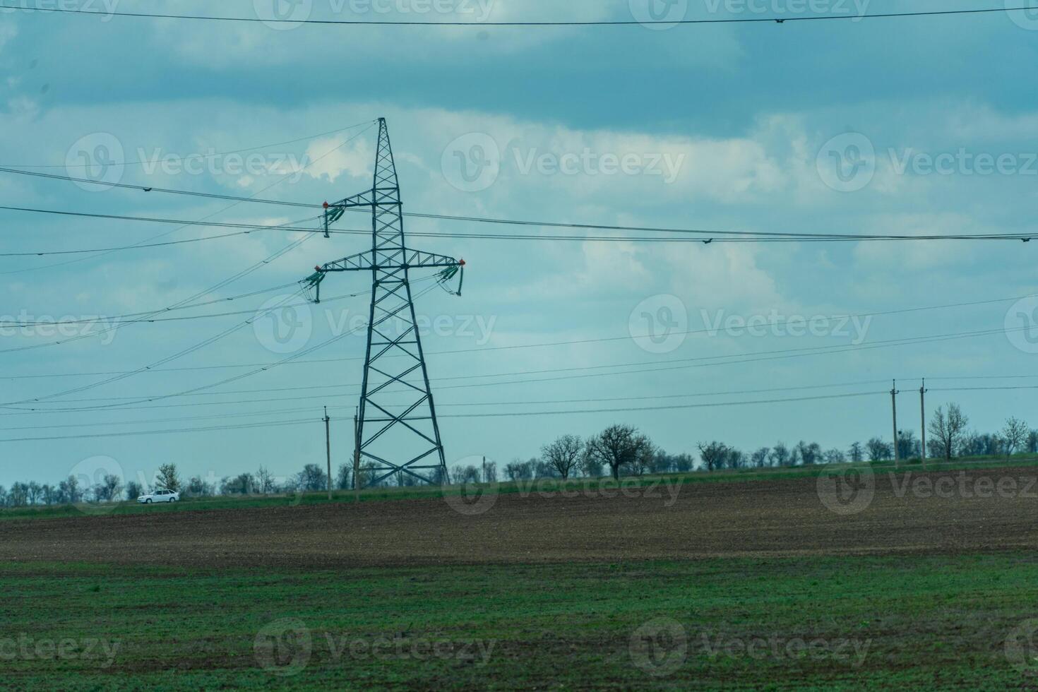 High voltage towers with sky background. Power line support with wires for electricity transmission. High voltage grid tower with wire cable at distribution station. Energy industry, energy saving photo