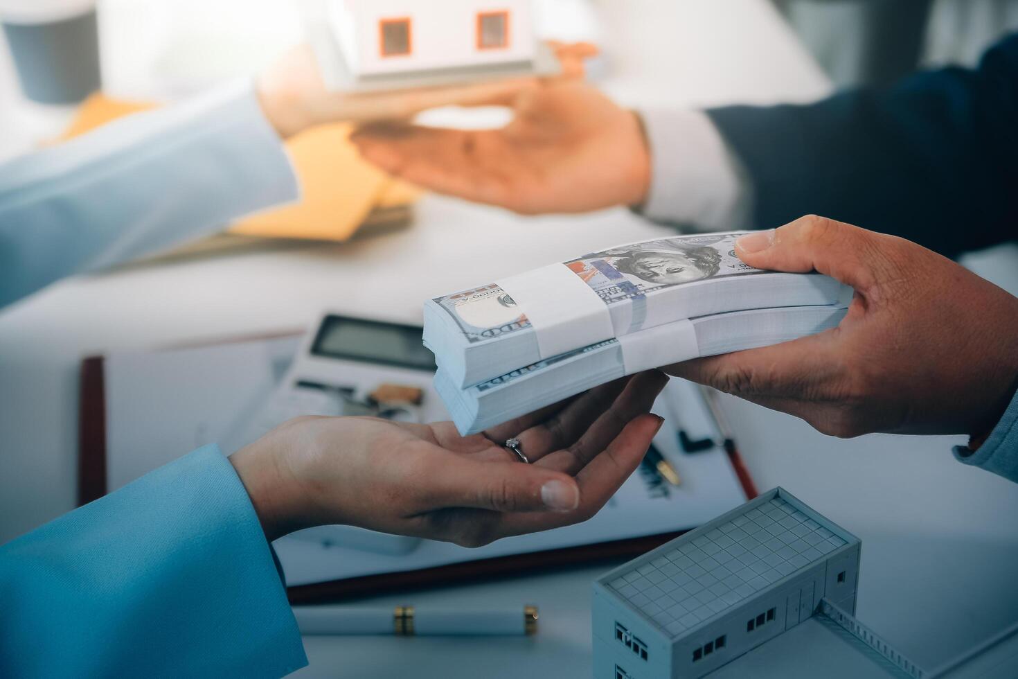Real estate agent talked about the terms of the home purchase agreement and asked the customer to sign the documents to make the contract legally, Home sales and home insurance concept. photo