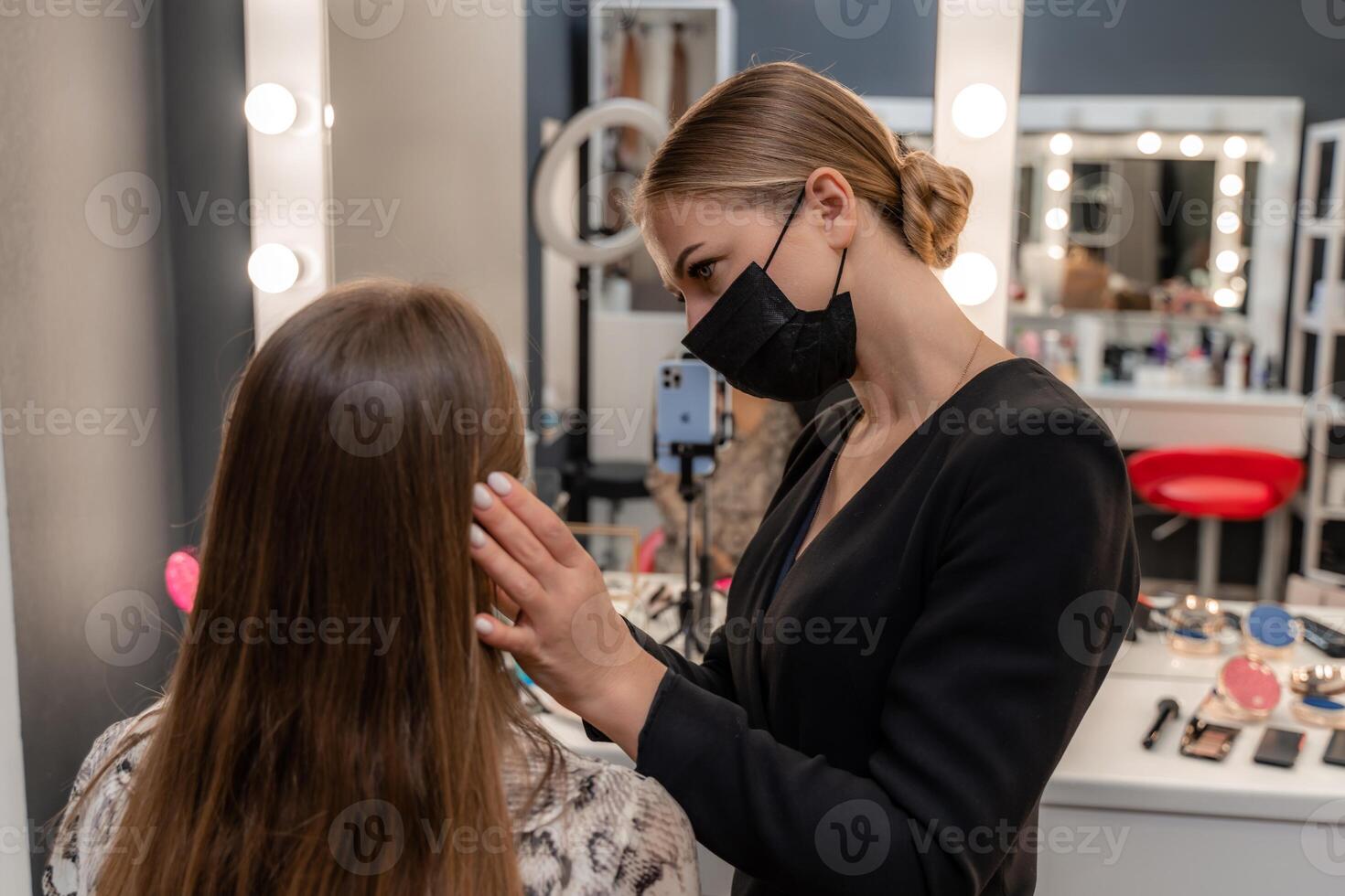 Make-up artist working with brush on model eyes Close up of applying make up on young girl,semi profile, professional make up in beauty studio photo