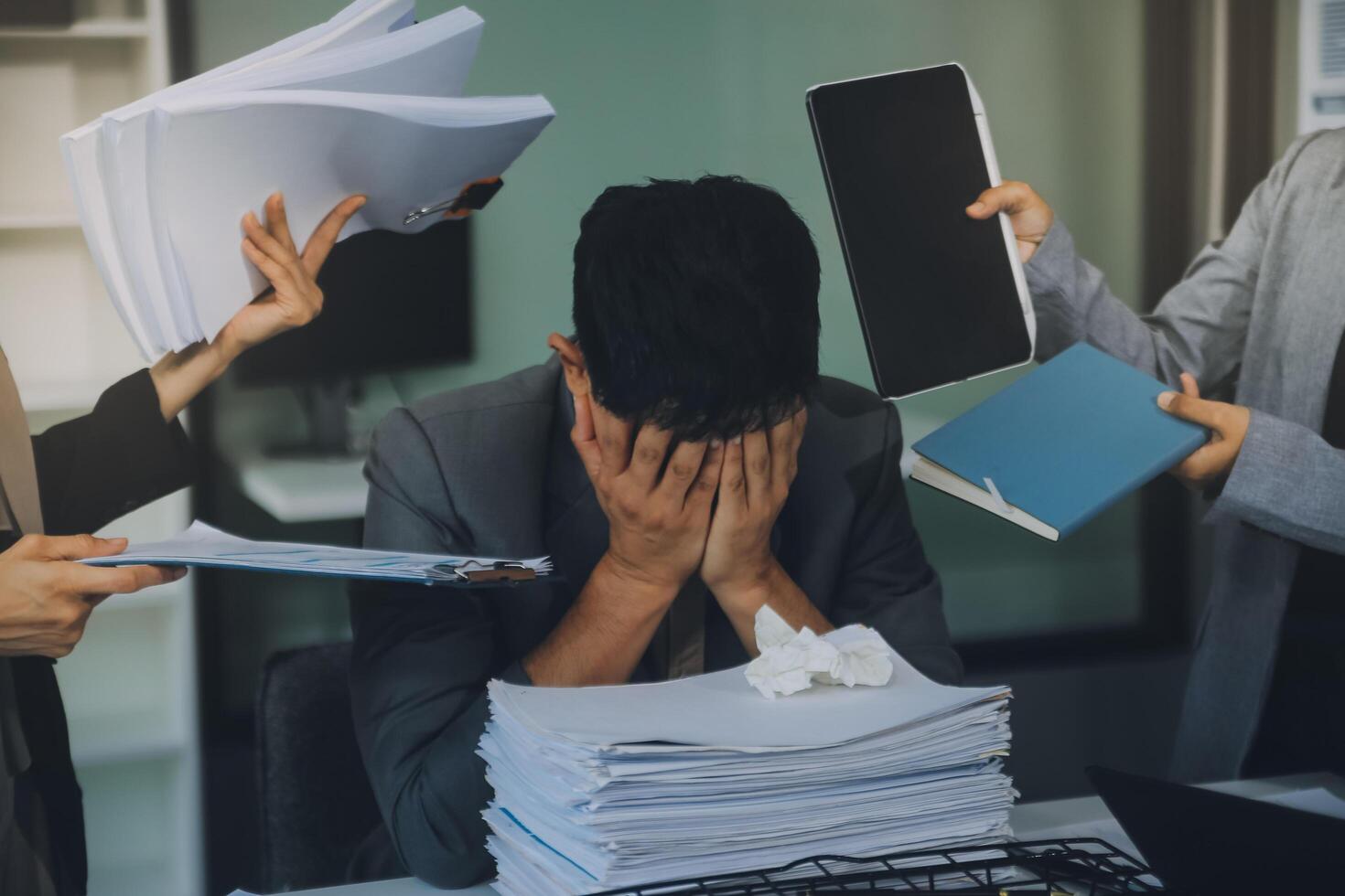 Stressful business man have so many paperwork in the office photo