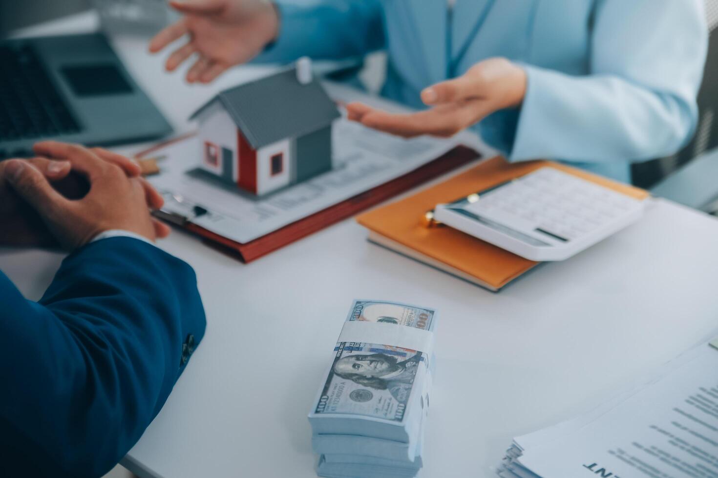 Real estate agent talked about the terms of the home purchase agreement and asked the customer to sign the documents to make the contract legally, Home sales and home insurance concept. photo