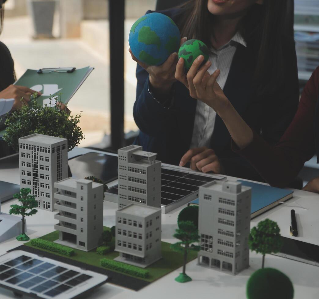 Business people having consultation about wind energy at company office. Business team discussing about windmill and alternative green energy. Executive meeting at modern office photo