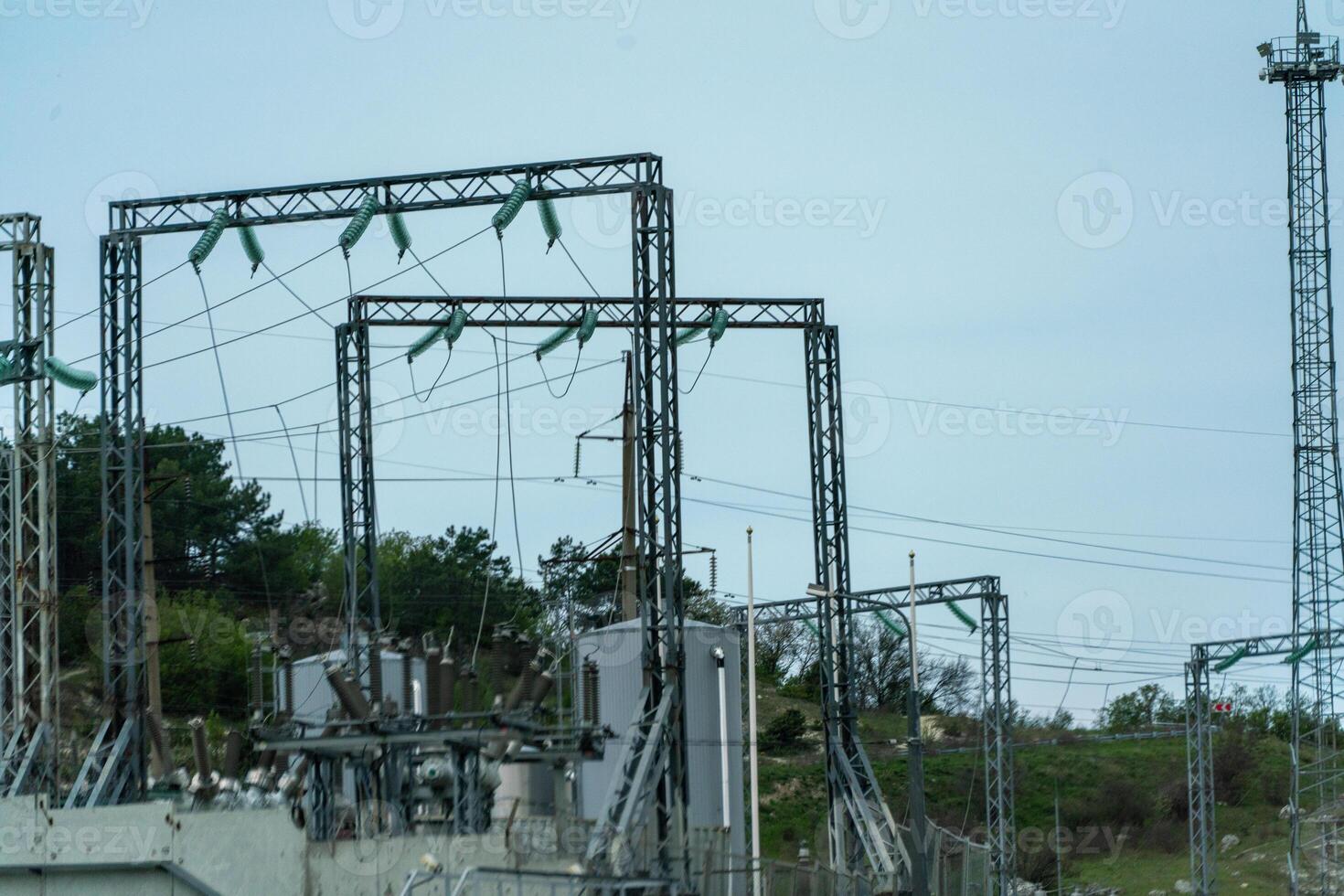 High voltage towers with sky background. Power line support with wires for electricity transmission. High voltage grid tower with wire cable at distribution station. Energy industry, energy saving photo