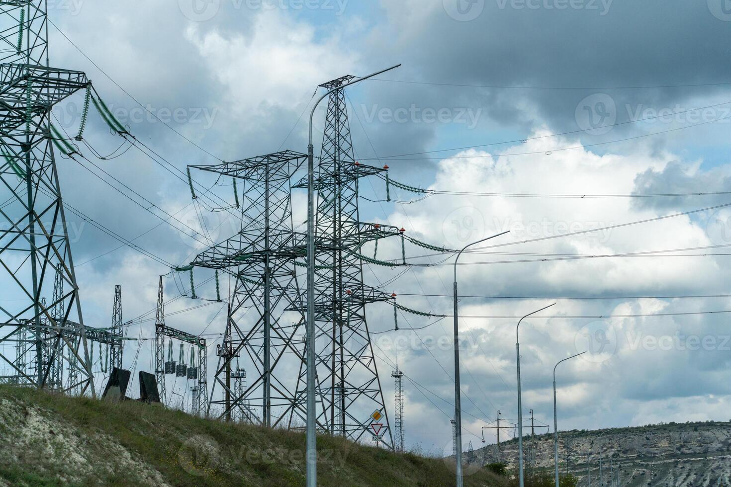 High voltage towers with sky background. Power line support with wires for electricity transmission. High voltage grid tower with wire cable at distribution station. Energy industry, energy saving photo