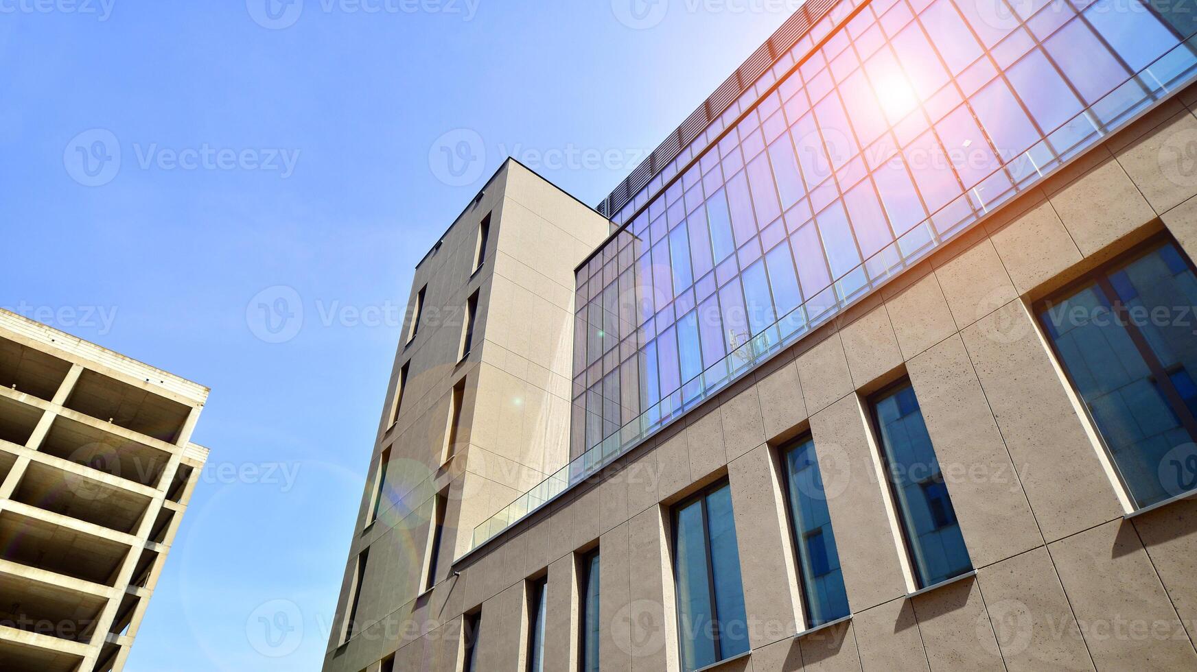 Modern office building detail. Perspective view of geometric angular concrete windows on the facade of a modernist brutalist style building. photo